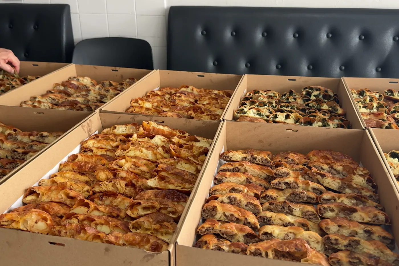 Open catering boxes filled with börek ready for delivery in Sydney