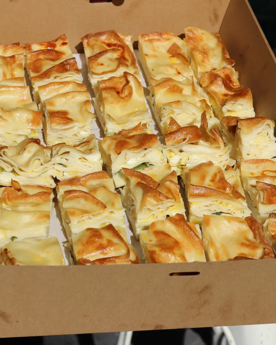 A full tray of ricotta and feta cheese börek squares