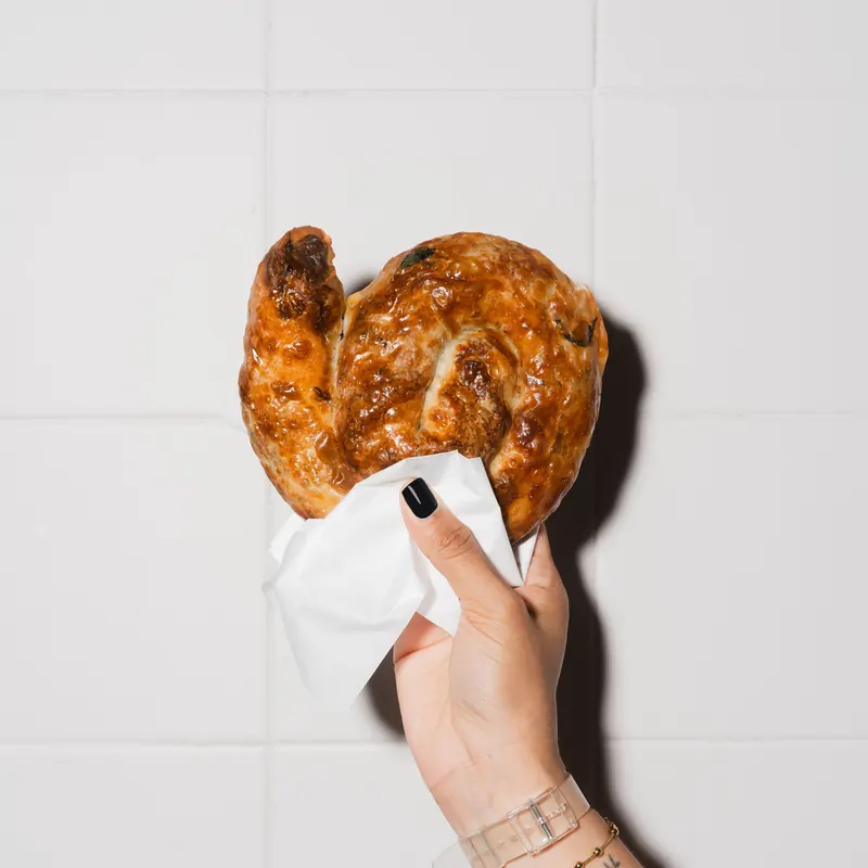 Golden rose börek held in hand