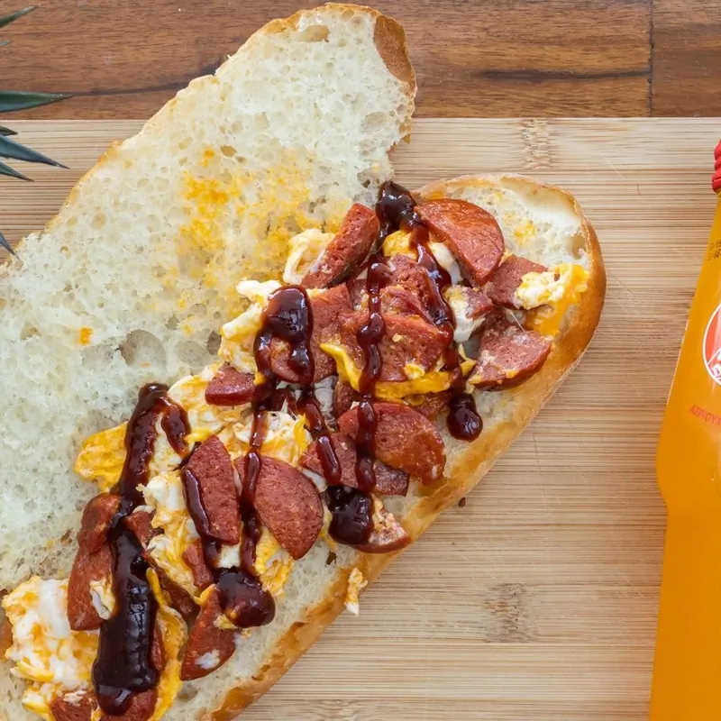 Sucuk, egg and cheese roll on a wooden board