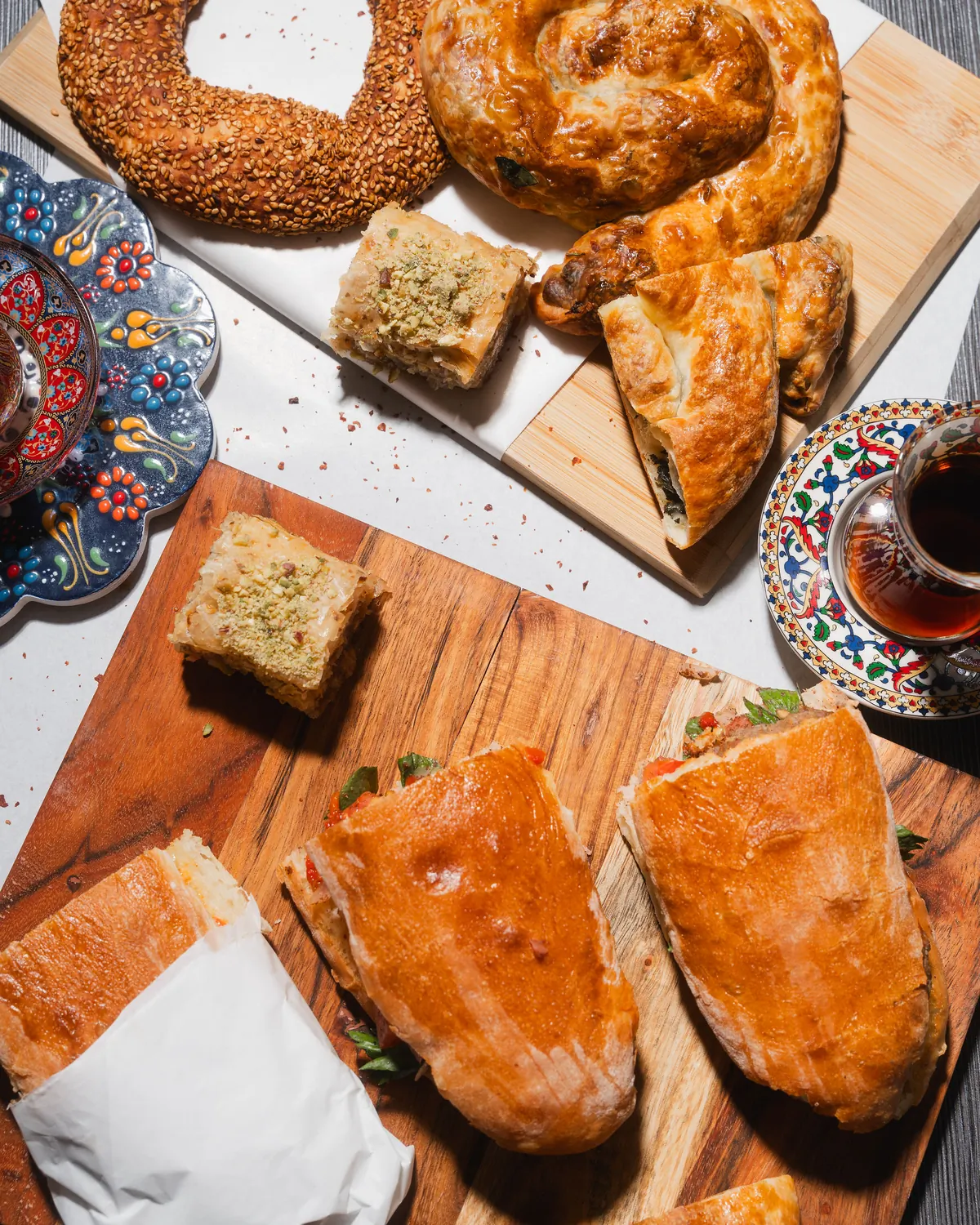 Turkish pastry catering spread with simit, börek, baklava and sandwiches