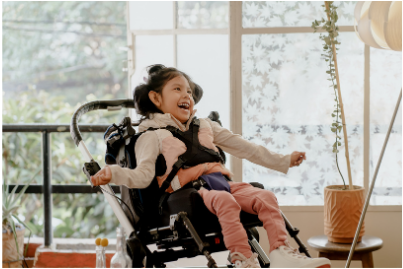 Girl with cerebral palsy smiling in wheelchair