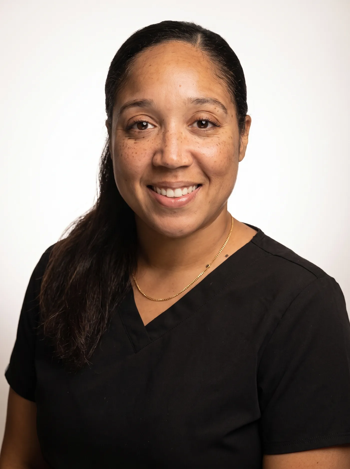 Ashley, specialist at Redefined Aesthetics and Wellness, smiling warmly