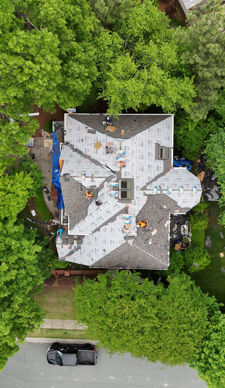 Roofed-In crew mid-installation on a large multi-gable home