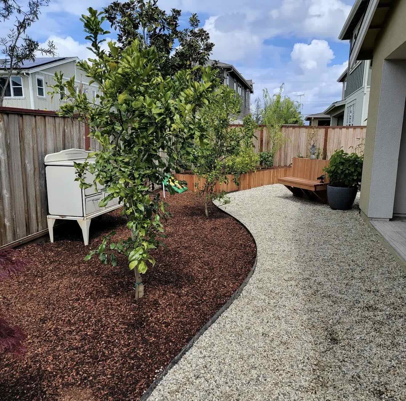 Landscape Design including new tree, mulch, and gravel walkway