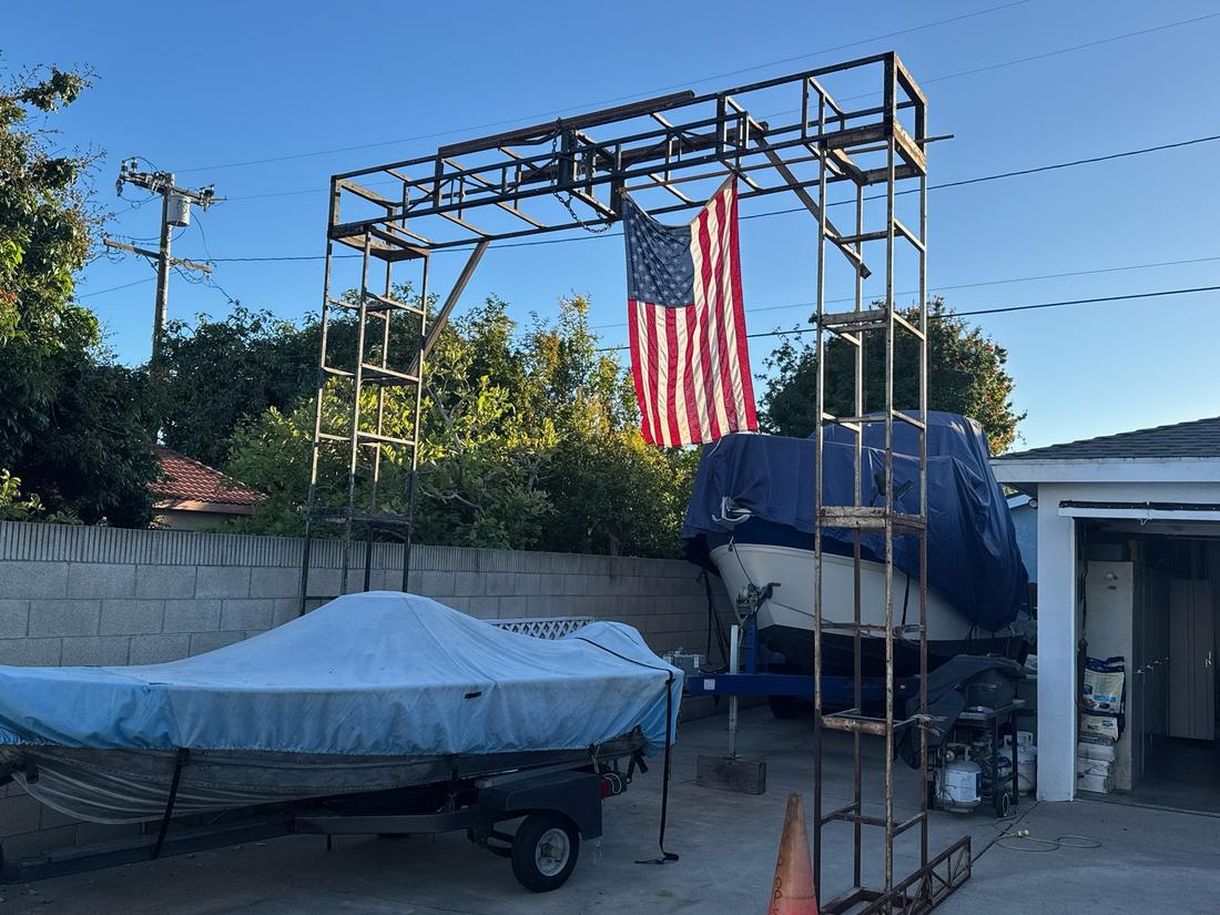 Boat serviced on a trailer in a residential driveway
