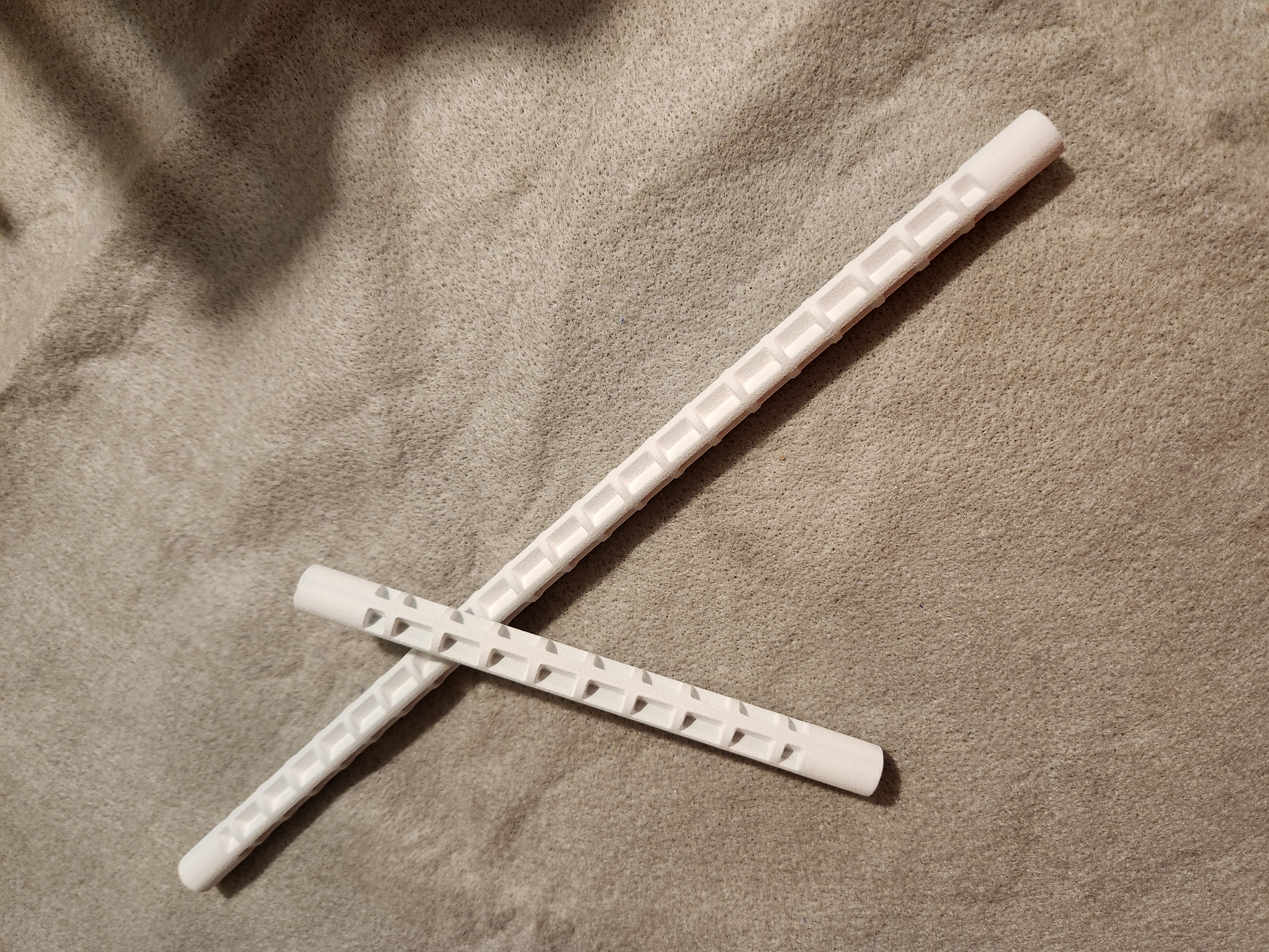 Mounting rod segments with ball studs at each end, close-up