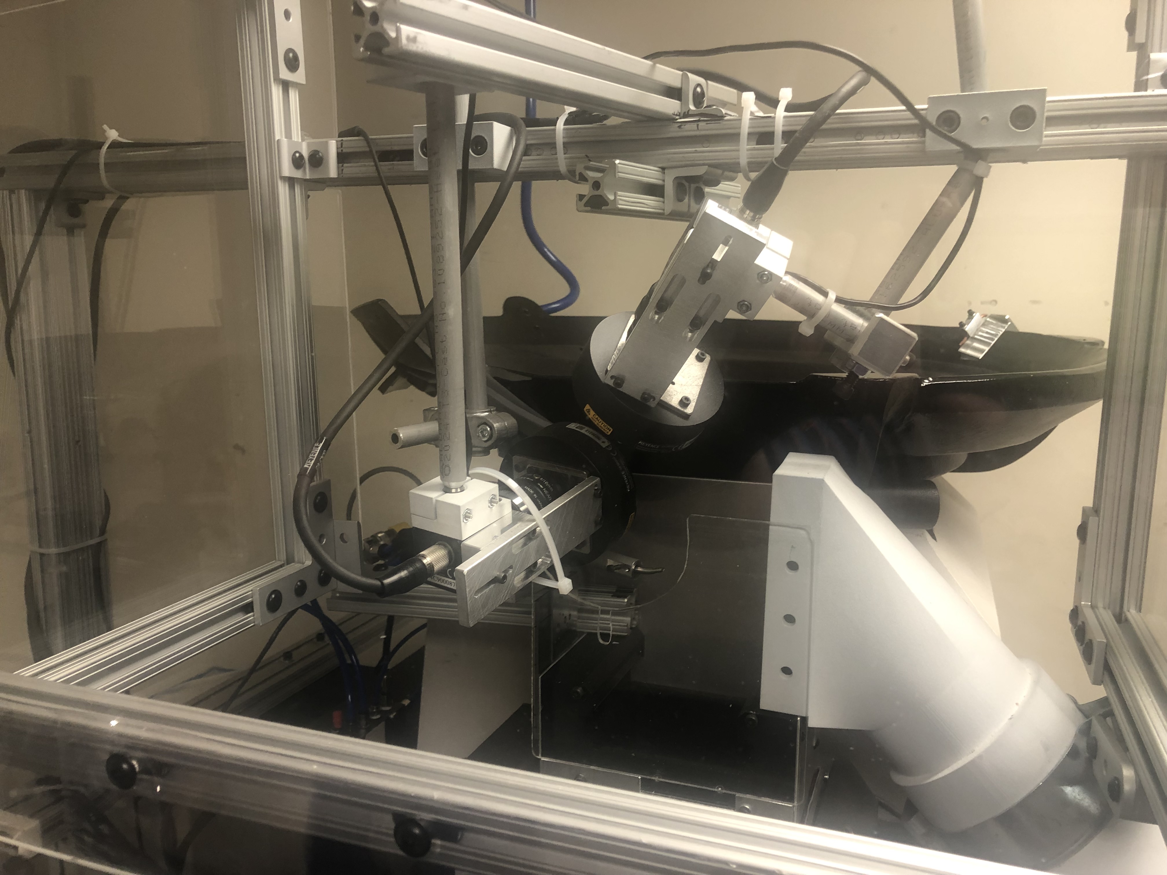 Universal mounting bracket holding a sensor in an industrial test fixture