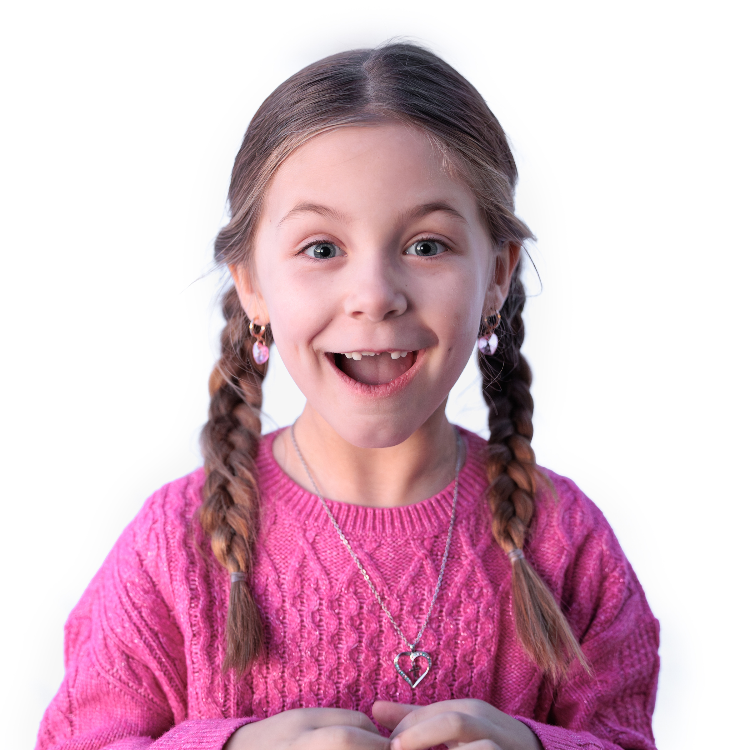 Excited girl with braided pigtails and a missing front tooth in a pink sweater, studio portrait