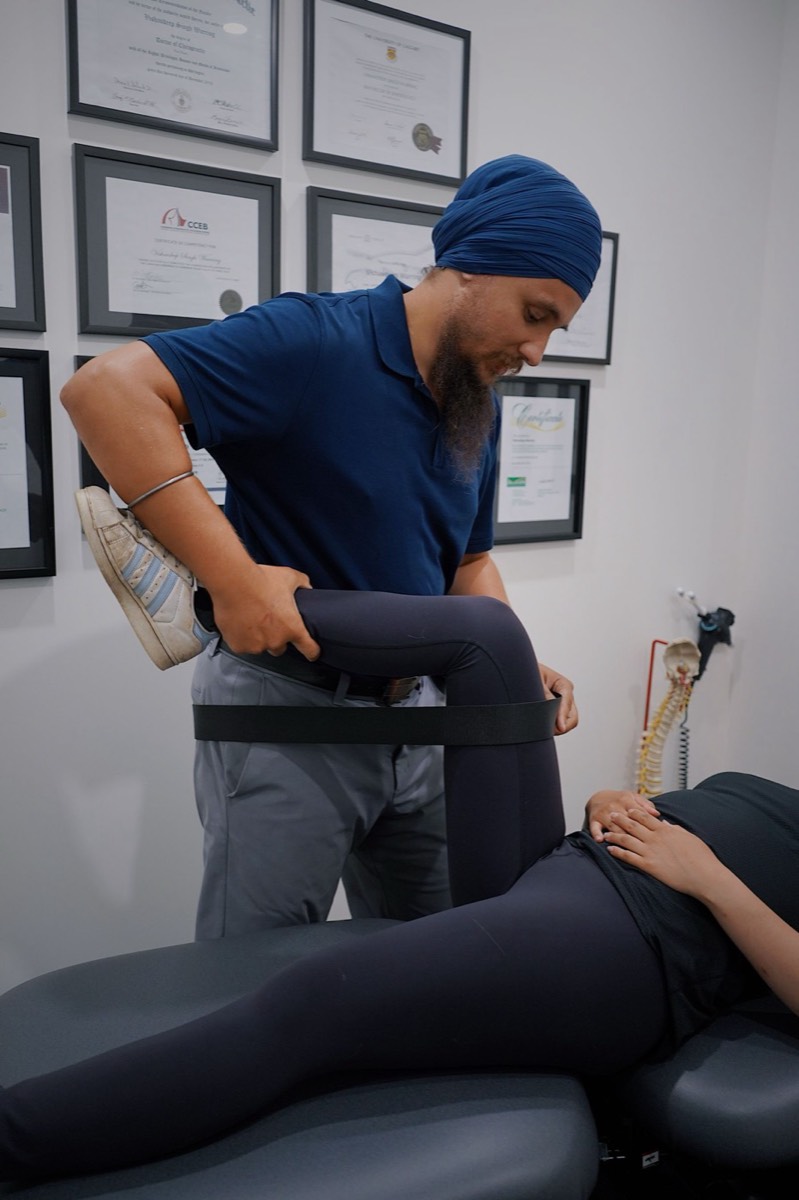 Physiotherapist guiding a patient through an exercise