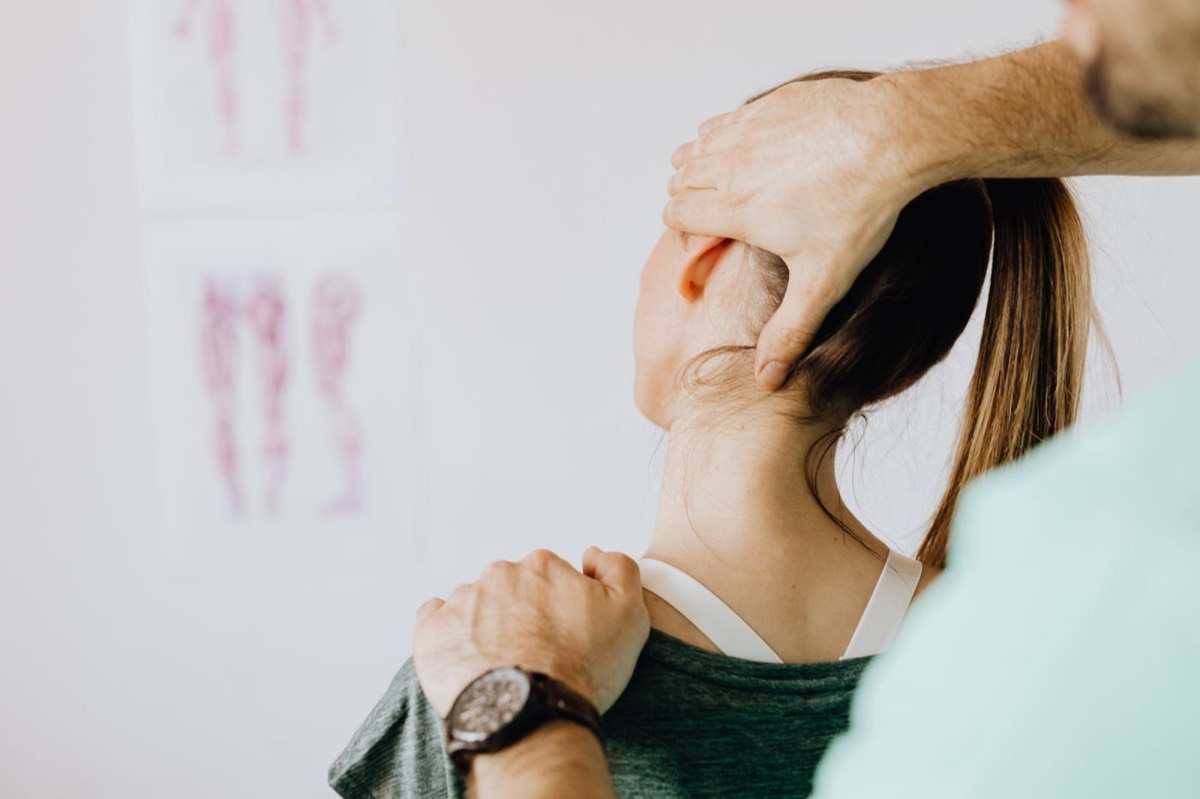 Clinician examining a patient's neck
