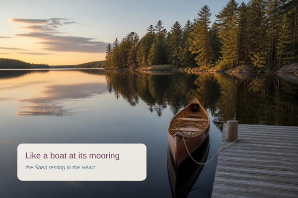 A wooden canoe tied at a dock on a still Muskoka lake at dusk: like a boat at its mooring, the Shen resting in the Heart
