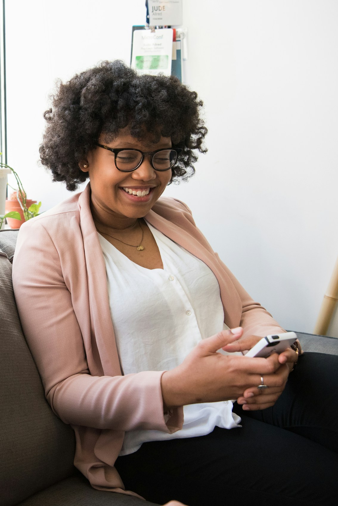 Woman smiling while looking at her phone