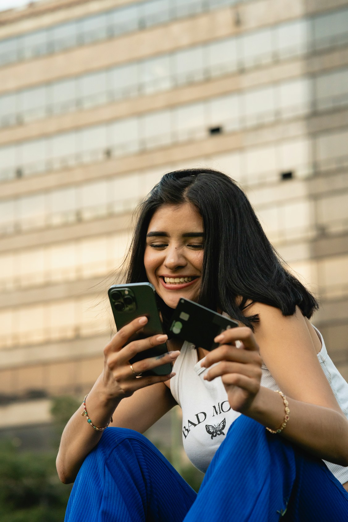 Digital product seller smiling with phone in hand