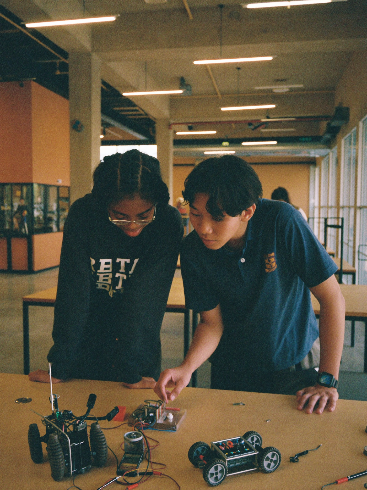 Two students building a robot in the STEM lab