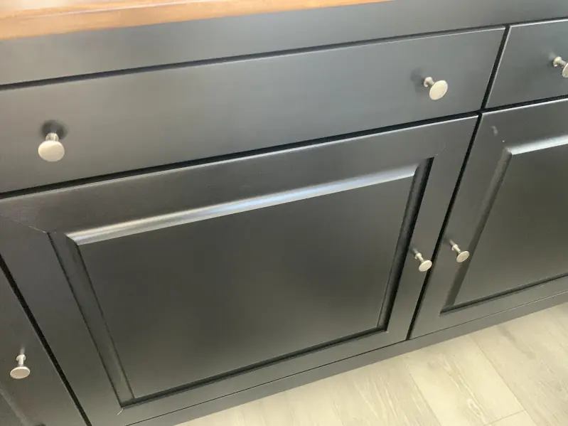 After photo of the same cabinet door with the scratch and scuff repaired and the finish blended.