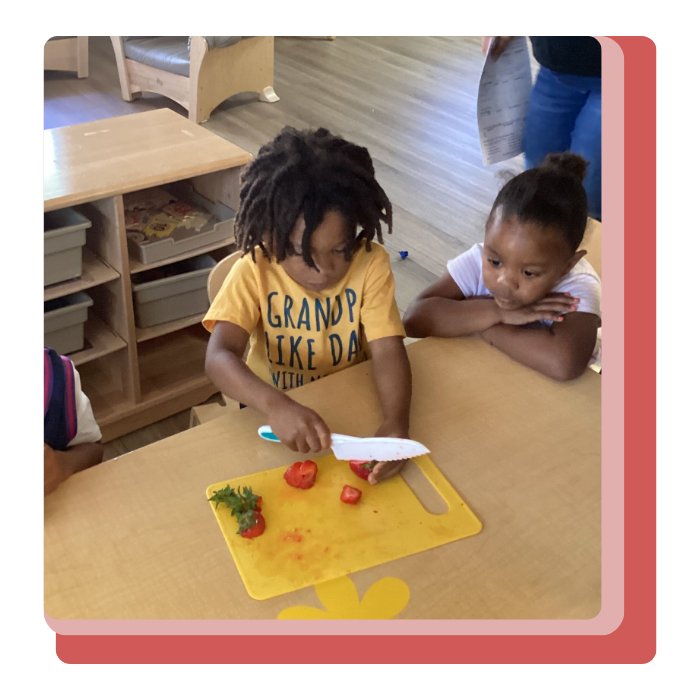 child cutting strawberries at day care