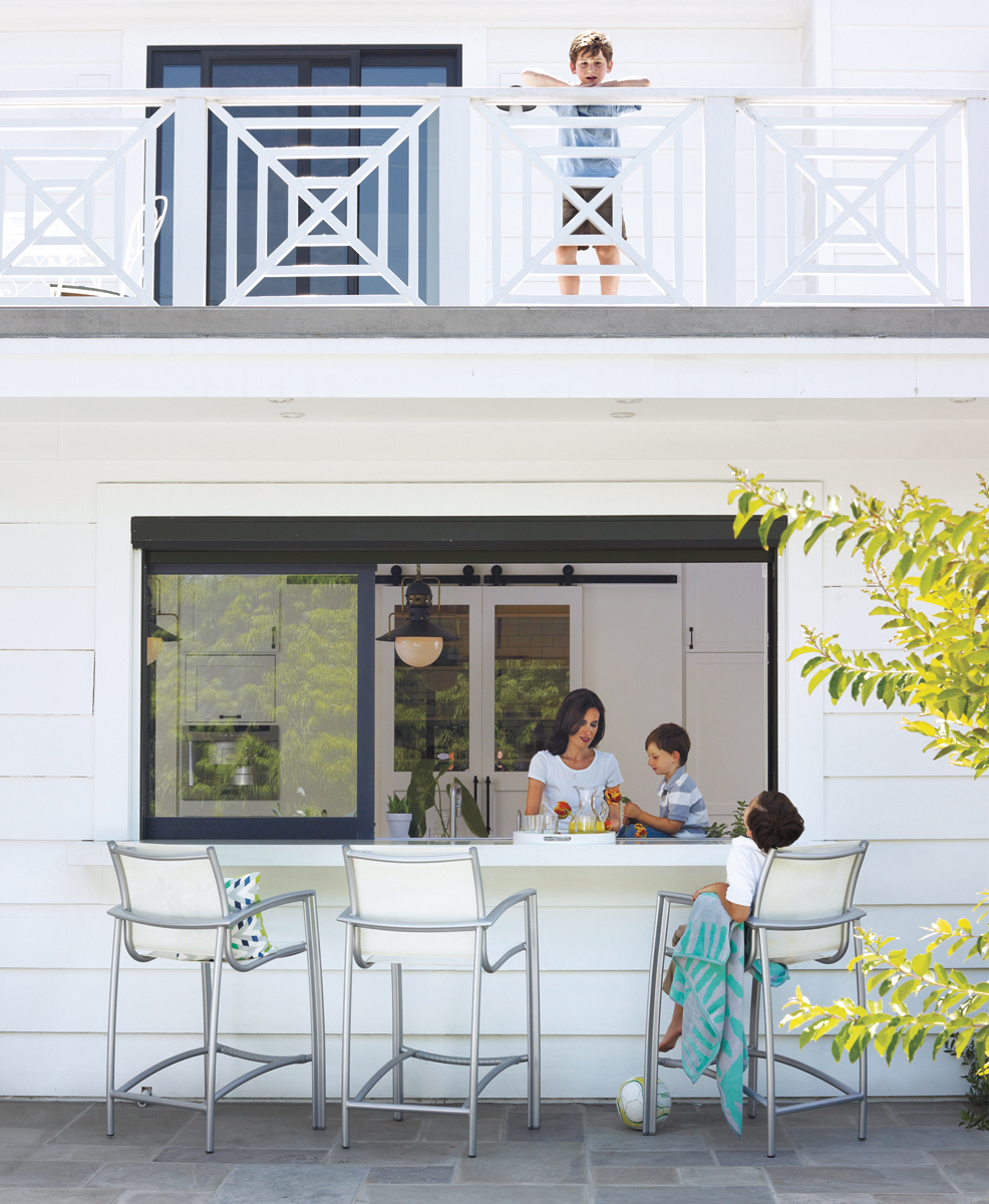 Family enjoying pass-through window outdoor kitchen