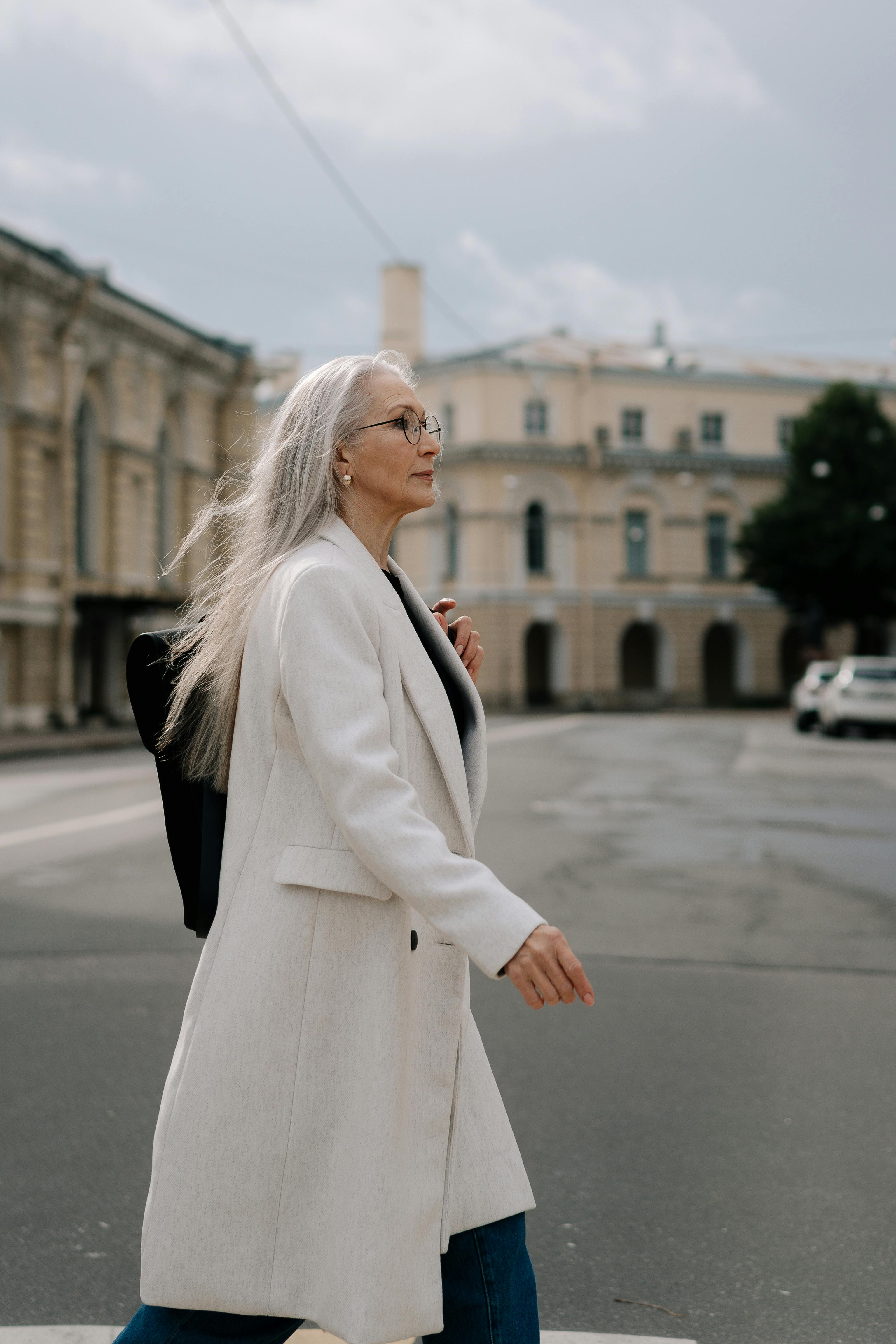 Midlife woman walking forward on a sunlit path representing the quiet steady rebuilding of self trust one small step at a time. Midlife woman walking forward on a sunlit path representing the quiet steady rebuilding of self trust one small step at a time.
