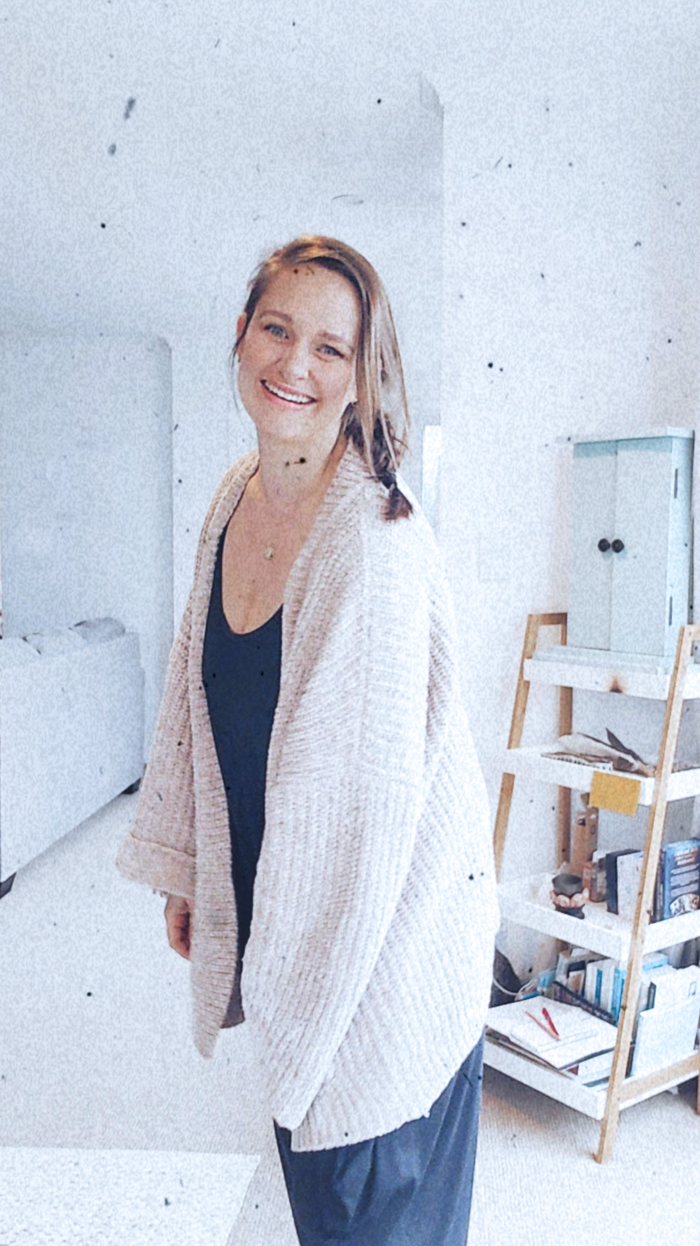 Half body black and white image of Shannon Neill, EFT Practitioner.  Standing position leaning slightly into the camera with relaxed arms and big smile.