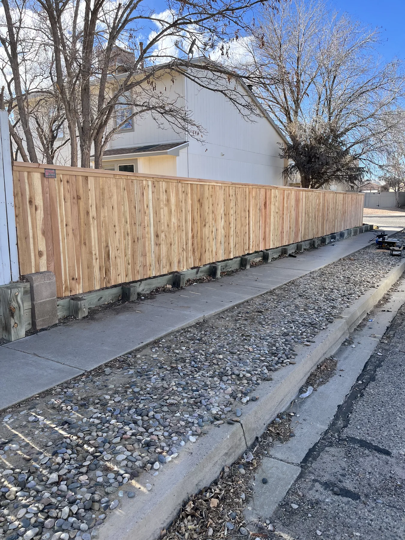 New wood privacy fence beside a home