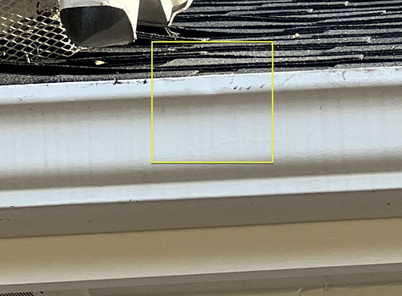 Hail dents and wind debris damage to gutters