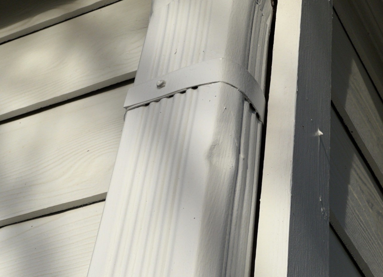 Hail damage to downspout