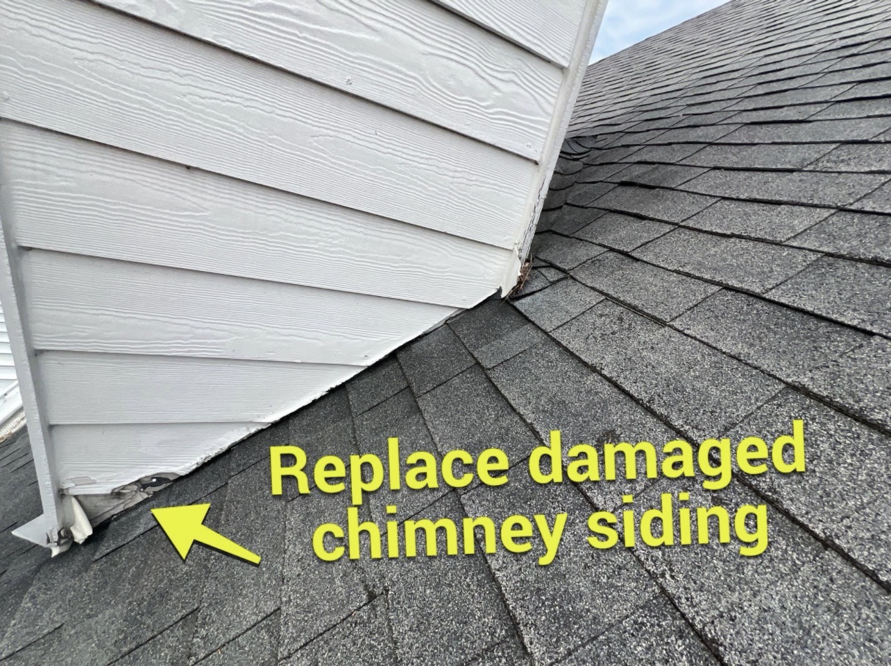 Damaged siding above chimney flashing