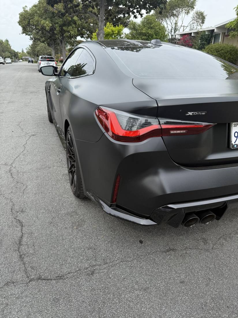 Matte black BMW M4 Competition rear