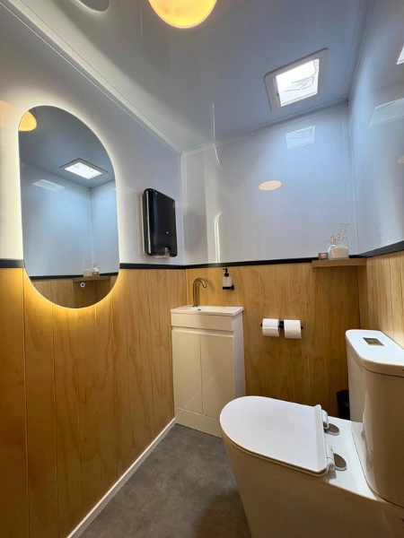 Premium luxury portaloo interior with modern fittings, mirror, lighting and clean bathroom finish