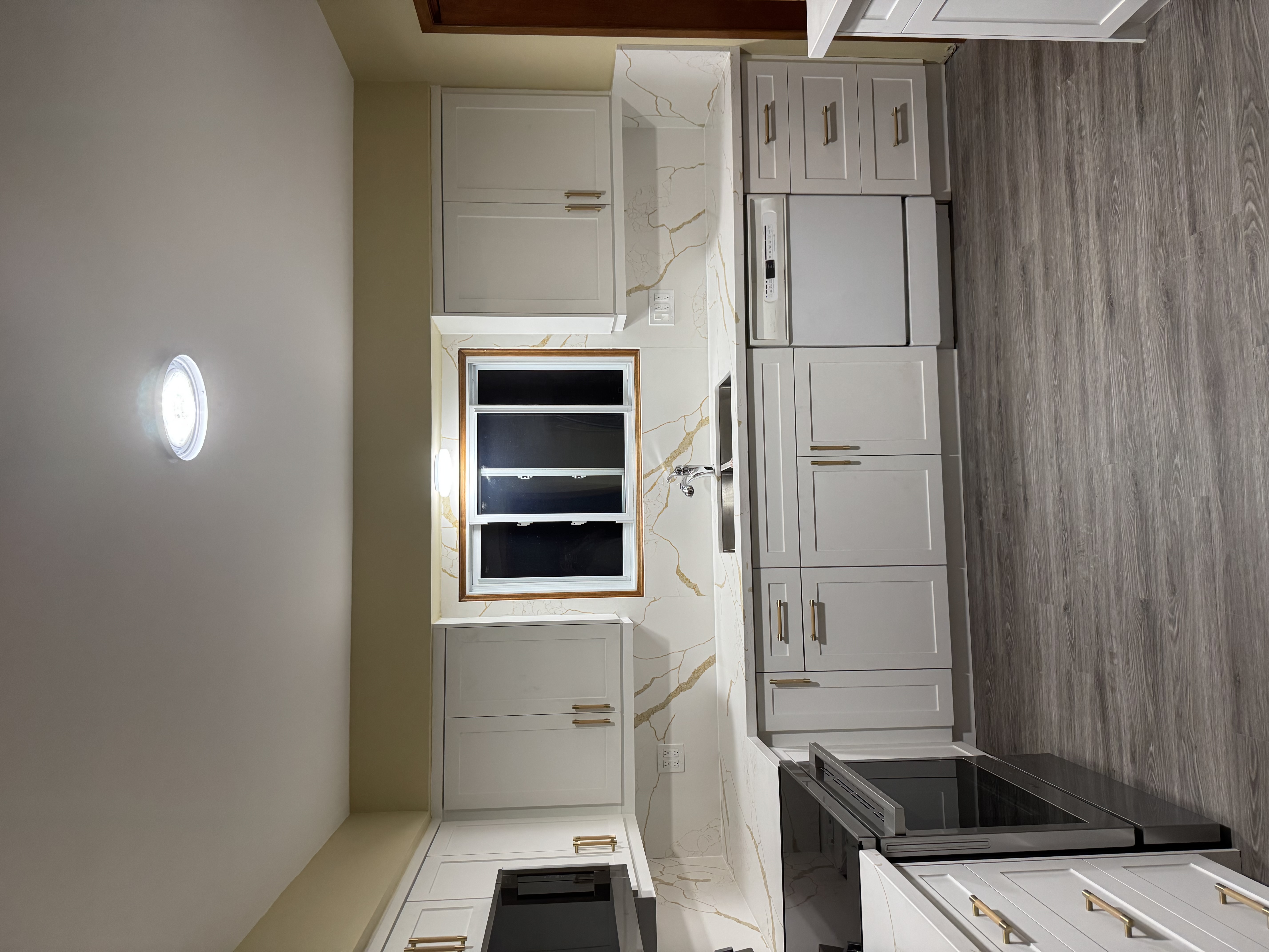 White kitchen with tan walls painted by Premier Pro Painting in Waterloo Region