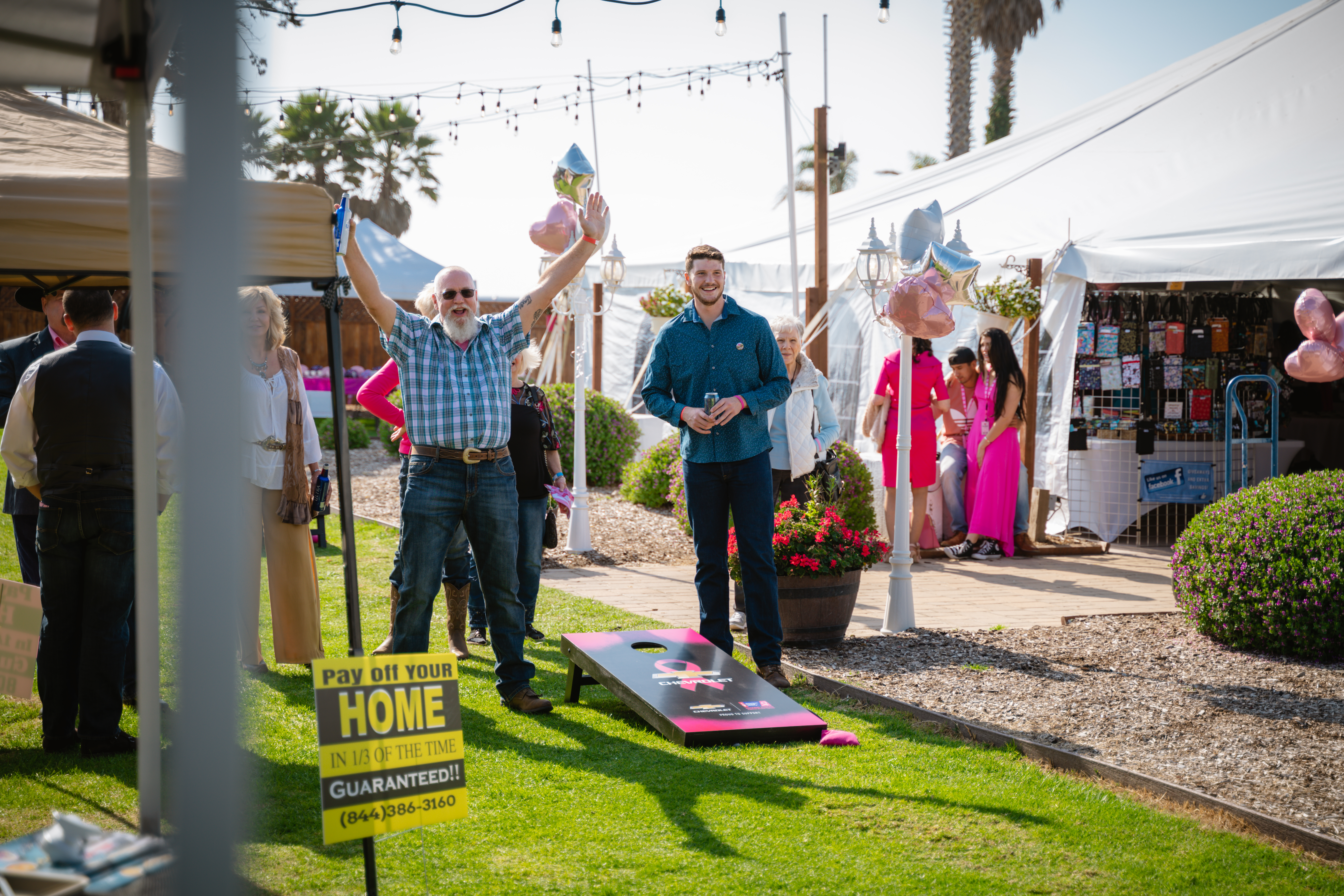 happy group playing cornhole
