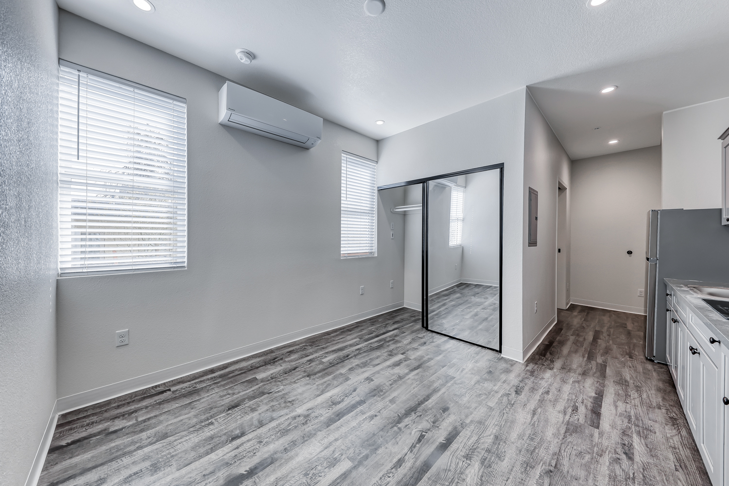 Studio living area with wall-mounted AC unit