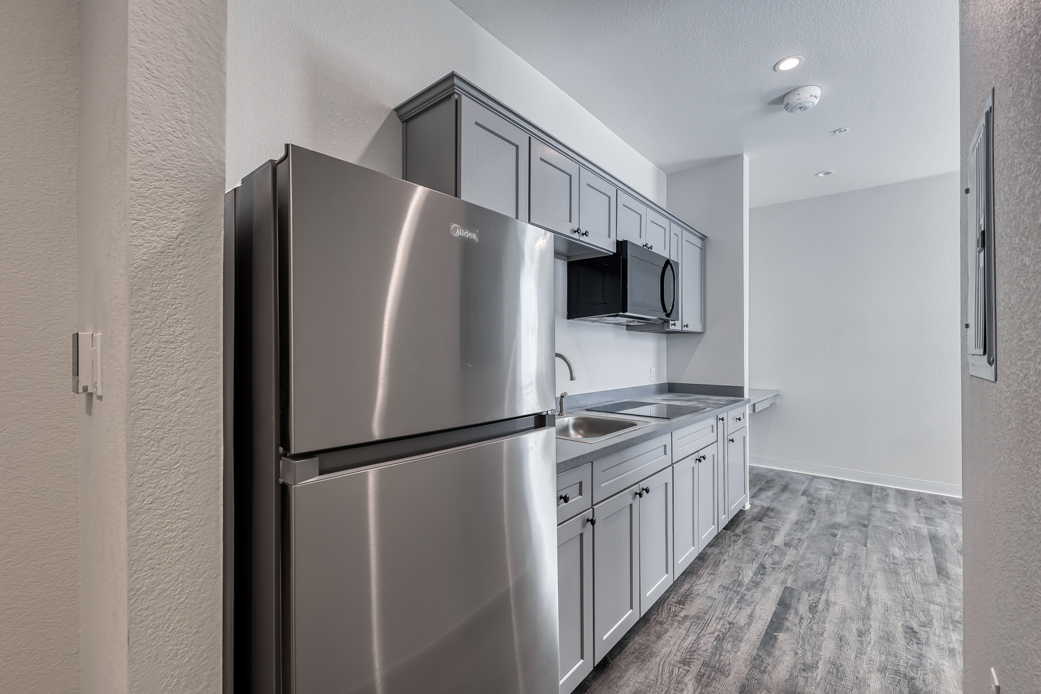Kitchen with stainless refrigerator and microwave
