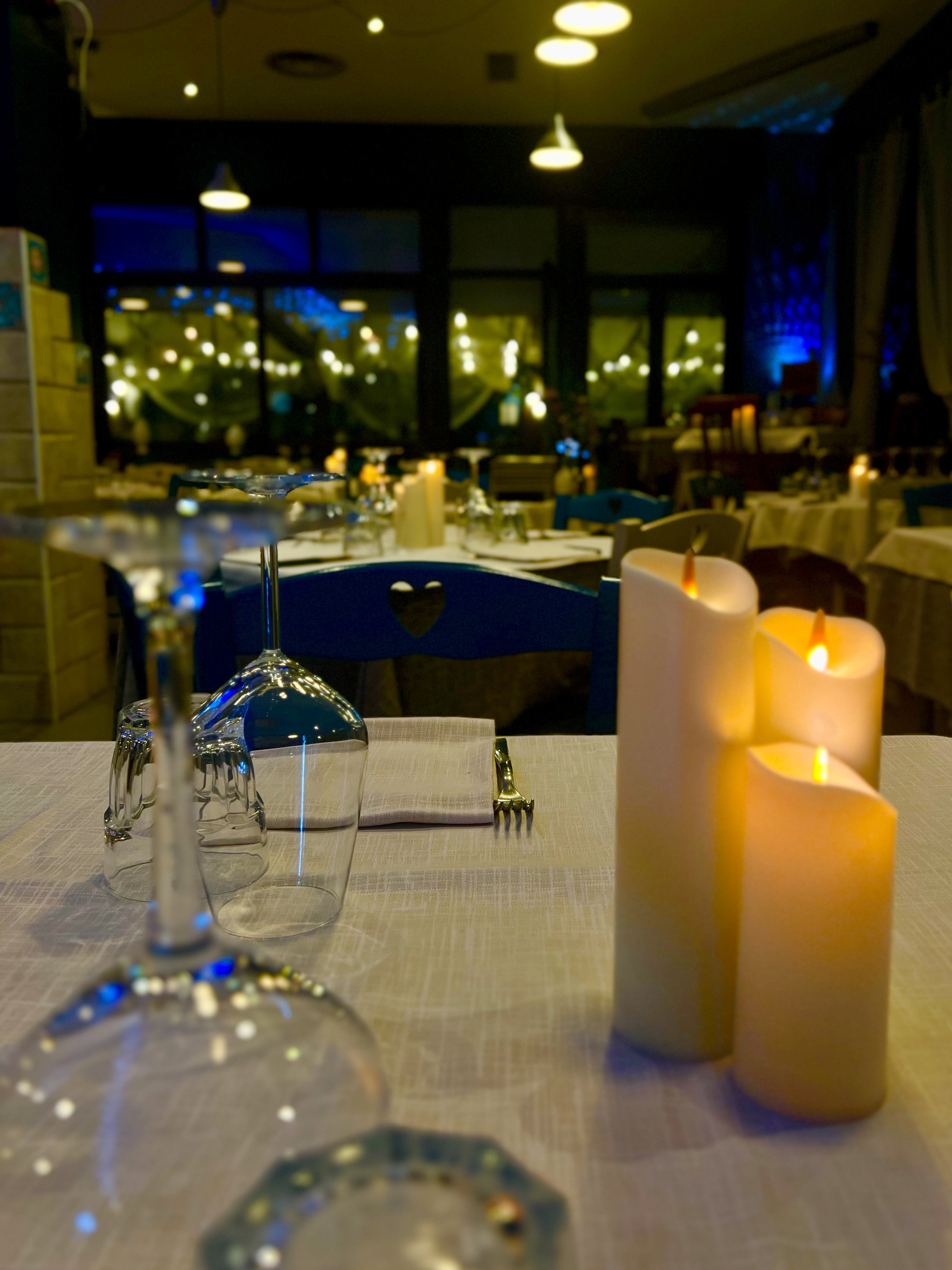 I tavoli apparecchiati di Sanfy, tra calici, candele e luci della sala