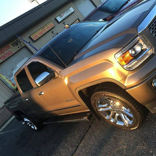 Gold GMC Sierra Denali with tinted windows and polished chrome wheels at Sir Wax A-Lot Detailing in Capitol Heights, MD