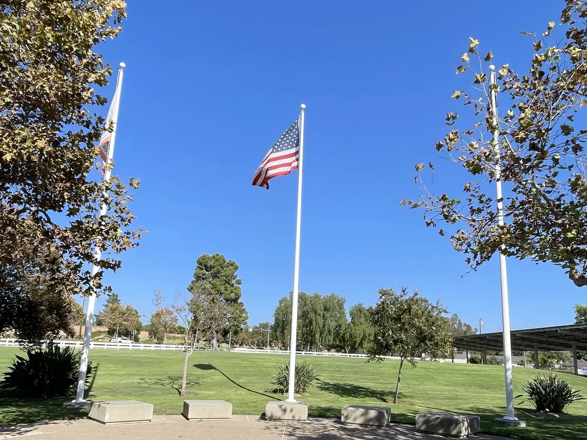 The three flag poles on the plaza at Yorba Linda Community Center, where meet-and-greets happen