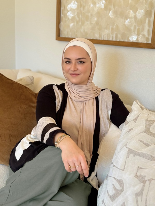 Nour sitting on a sofa