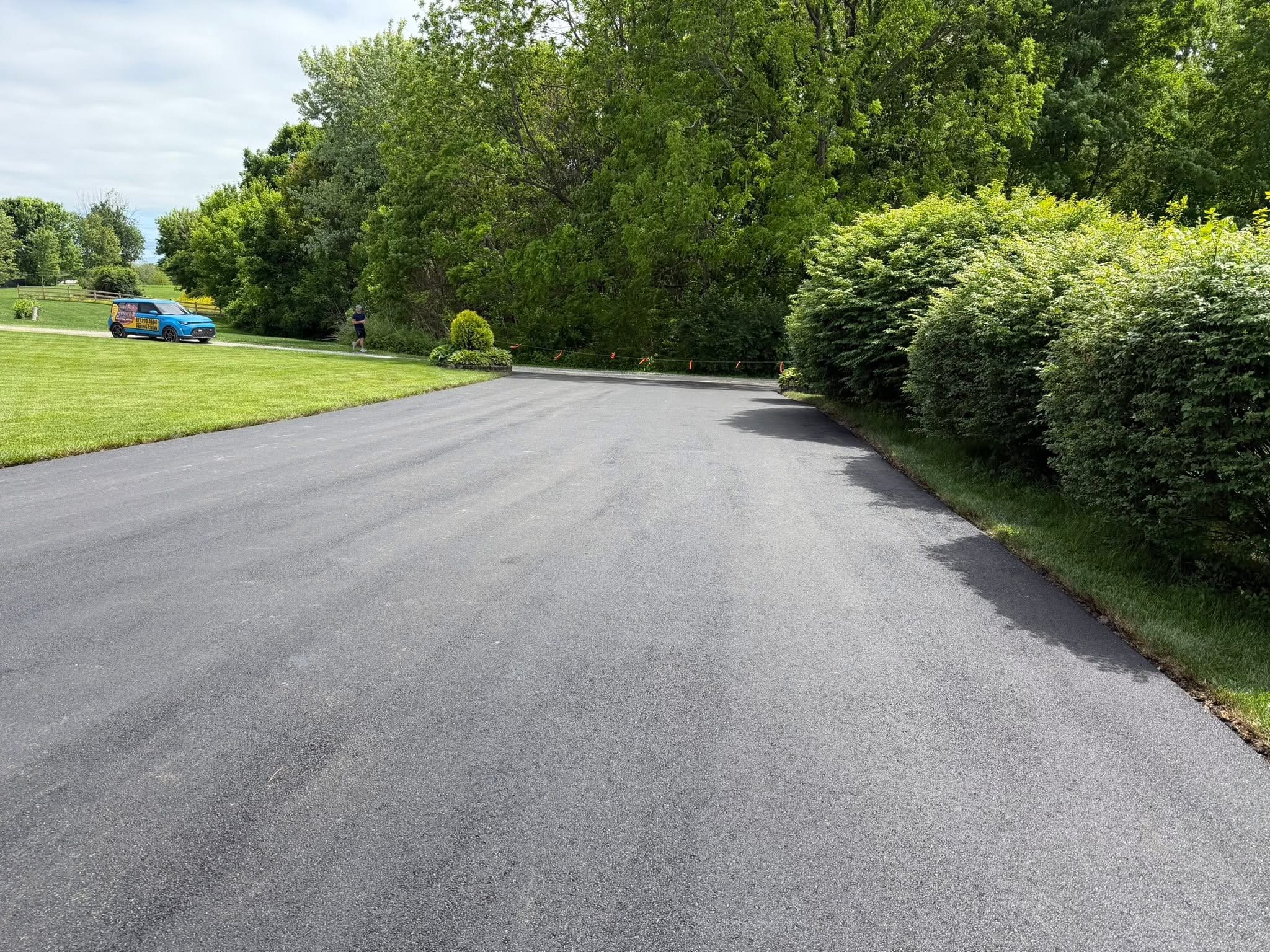 Professional seal coating on an asphalt driveway in Chesterfield, MO