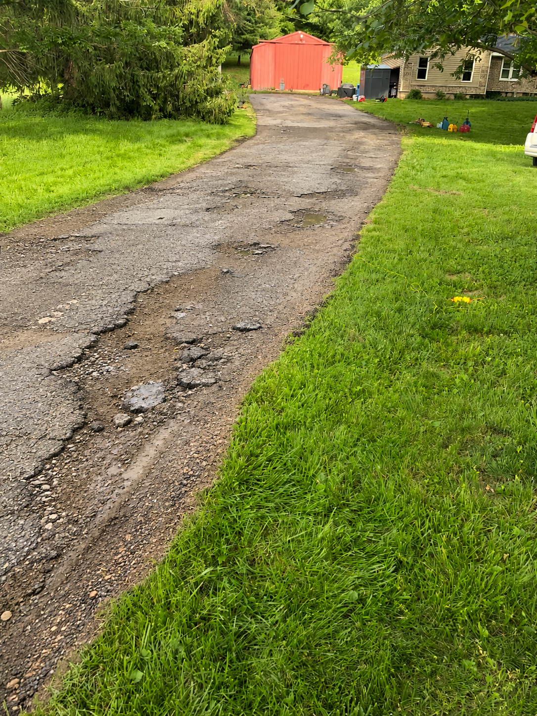 Before — worn asphalt surface before paving