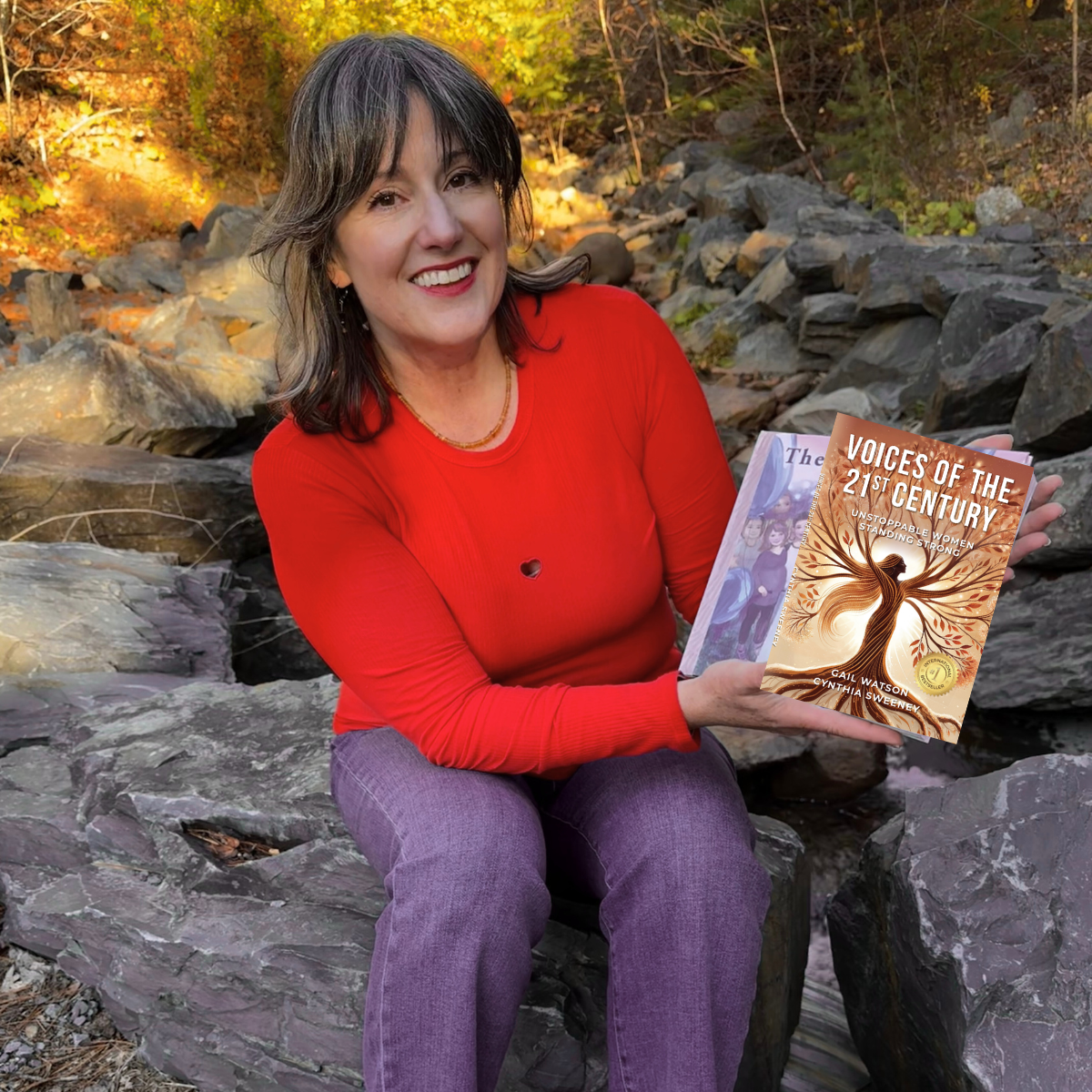 Cynthia Sweeney holding books and sitting outside