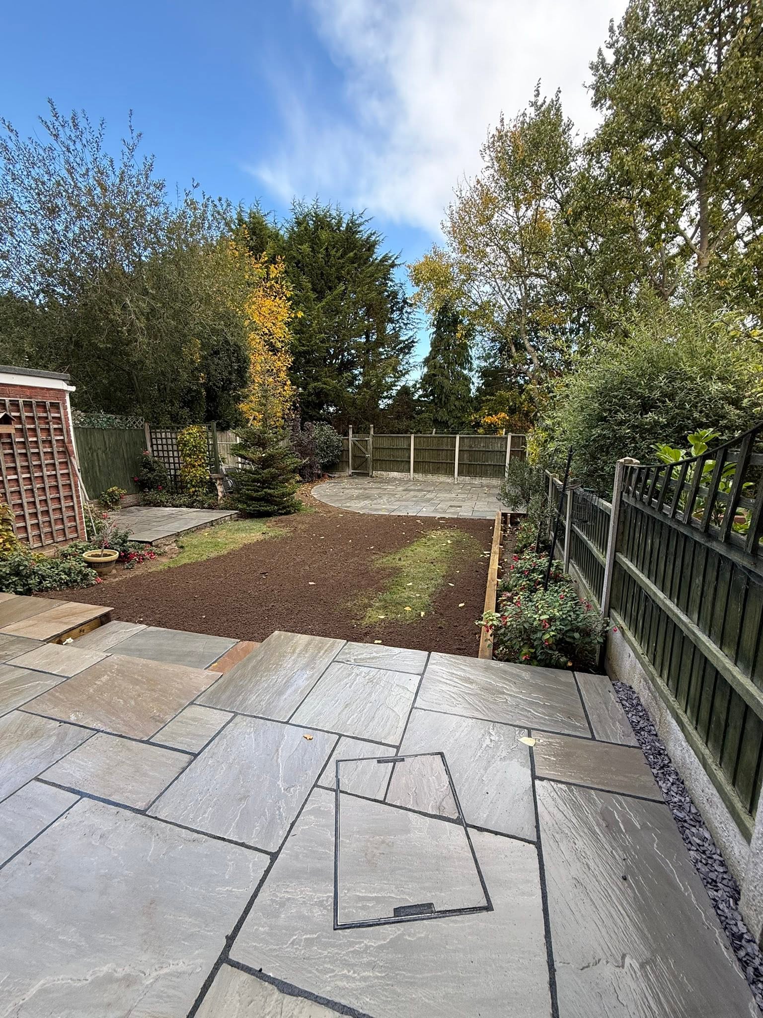 Garden transformation after: Indian stone paving and lawn