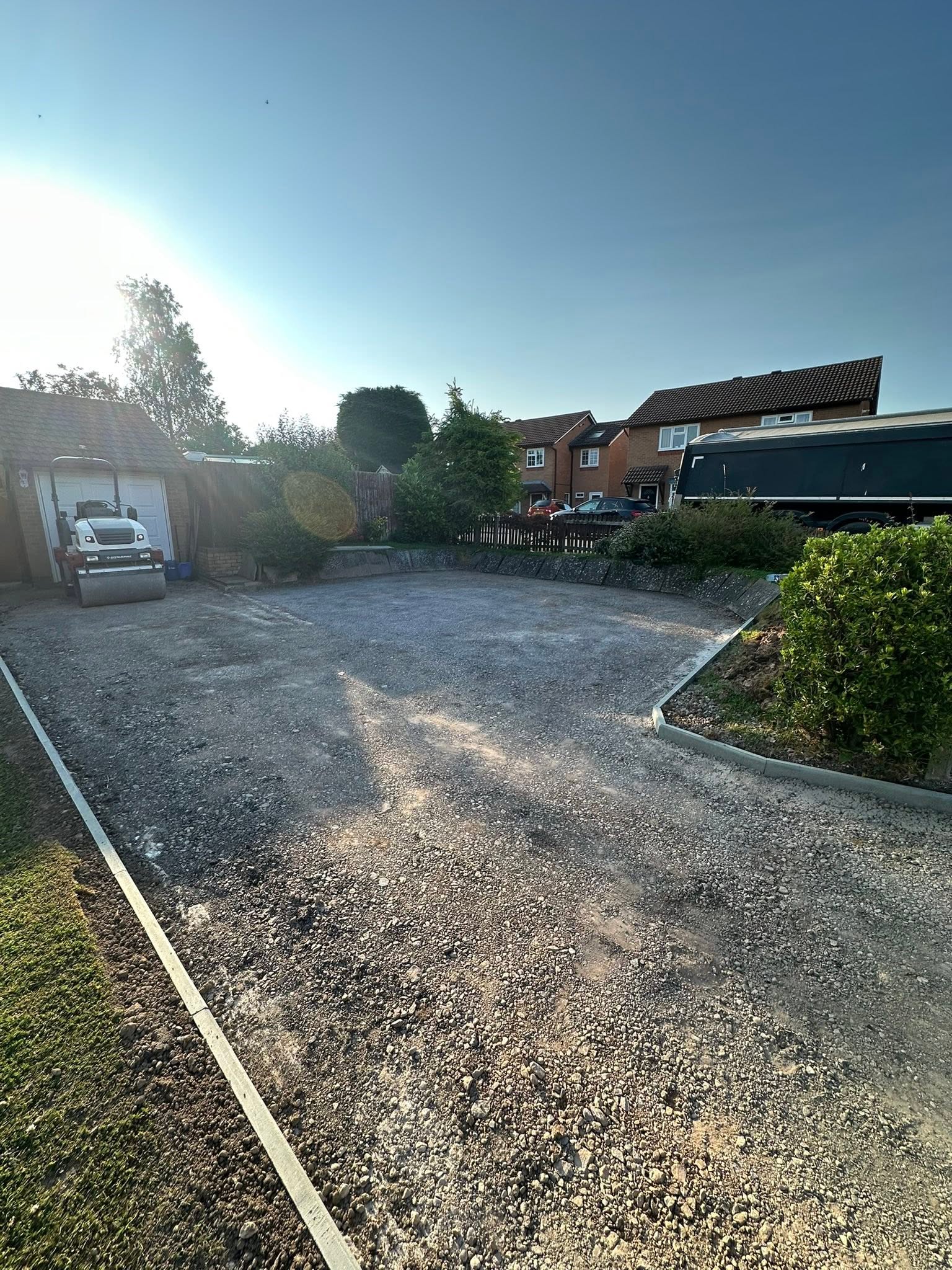 Tarmac driveway before: old gravel and uneven ground
