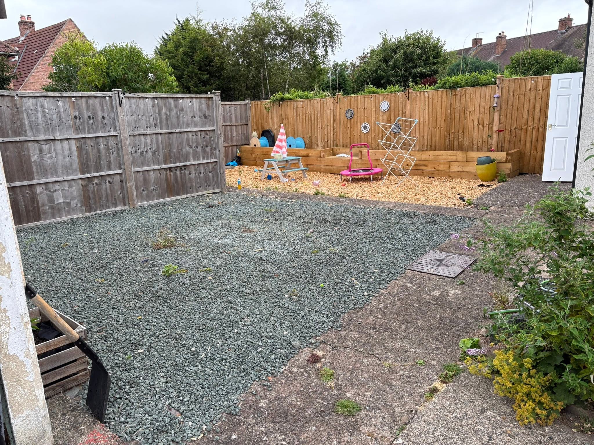 Indian stone patio before: cracked concrete and loose gravel removed
