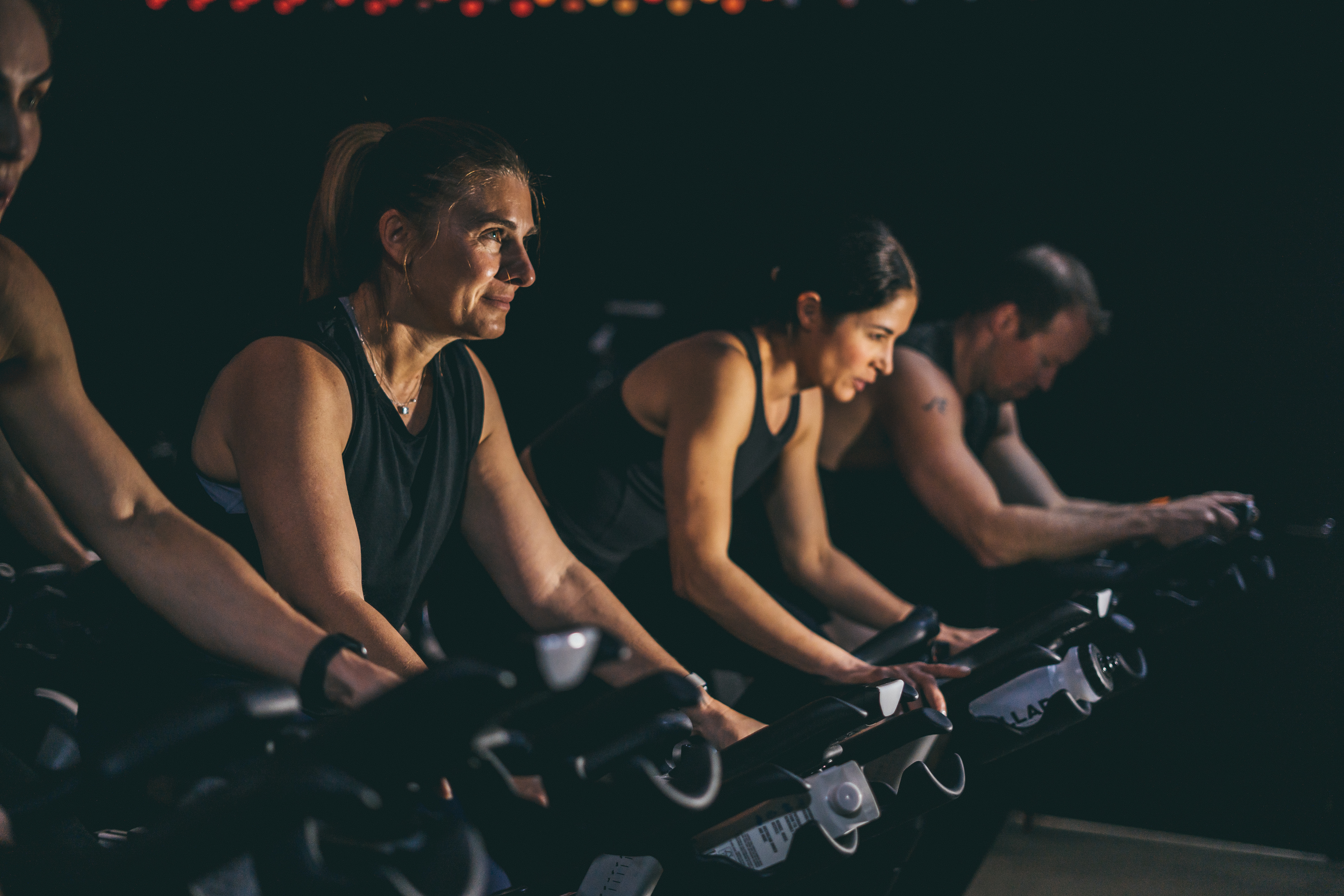 Members training with energy in a Flow Athletic cycle class