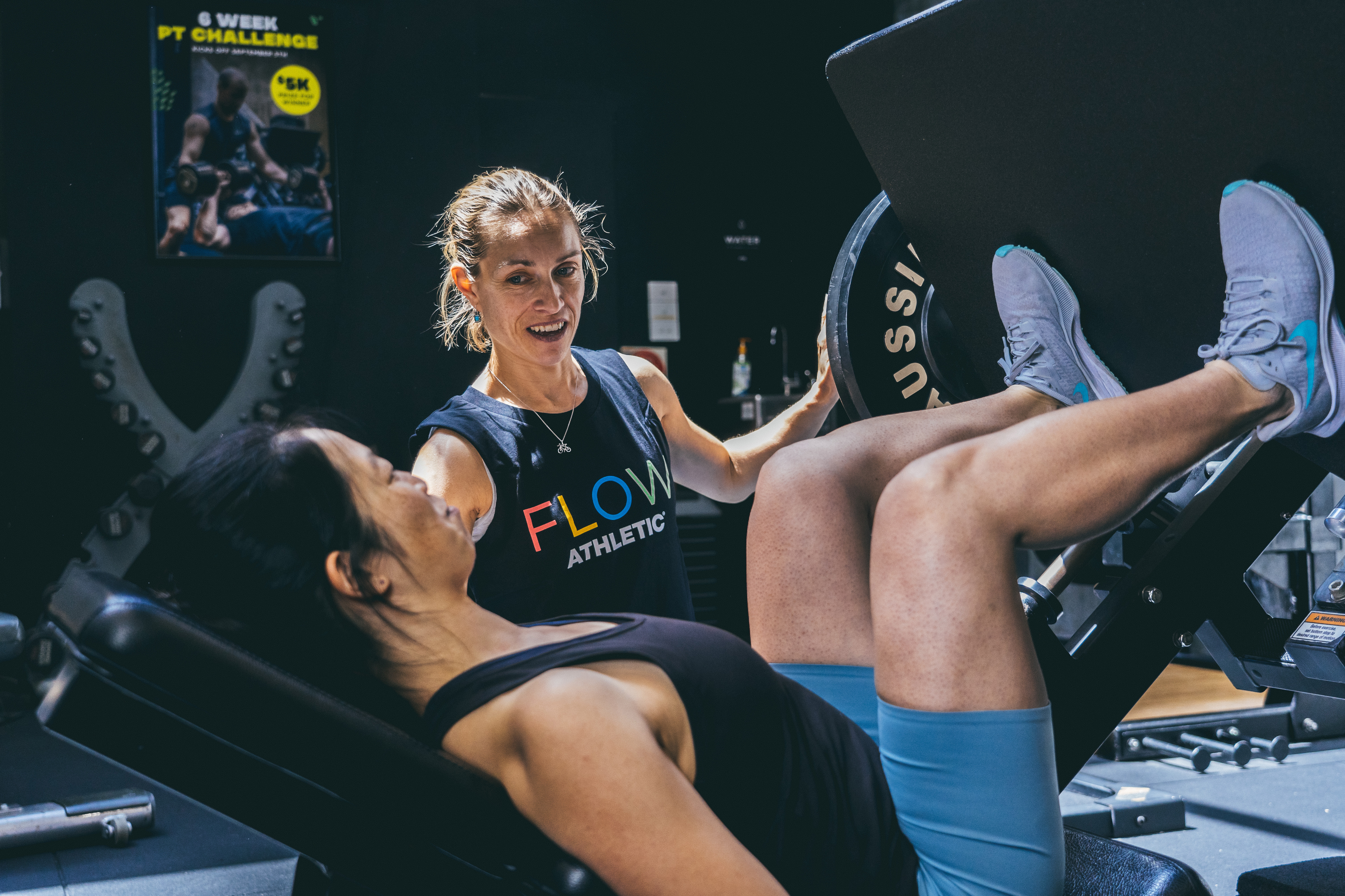 A Flow Athletic coach supporting a member during personal training