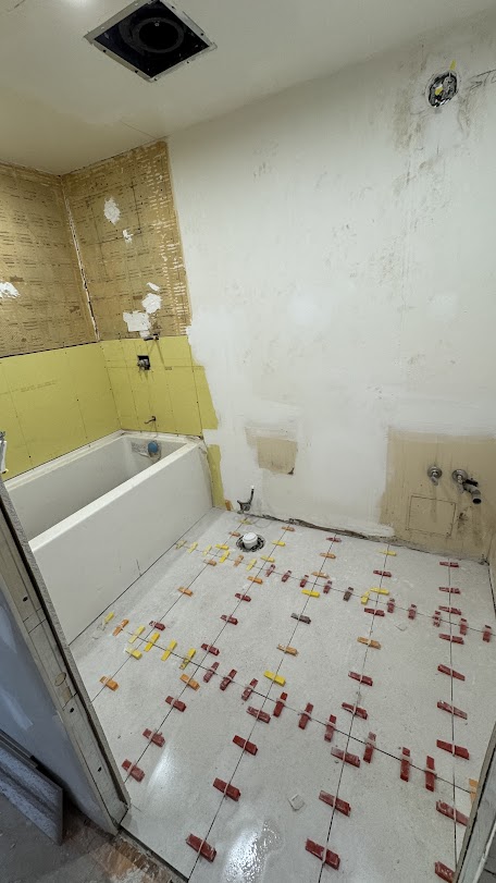 Demolition and floor tiling in progress