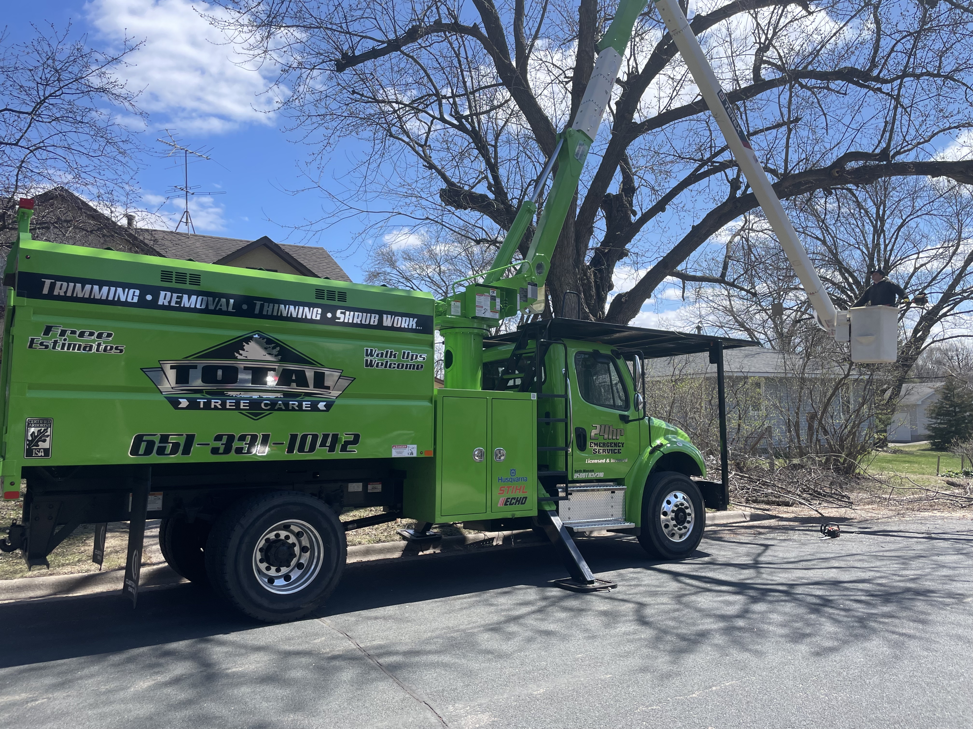 A Total Tree Care crew truck parked on a St. Paul residential street