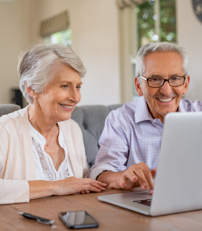 person using both laptop and smartphone