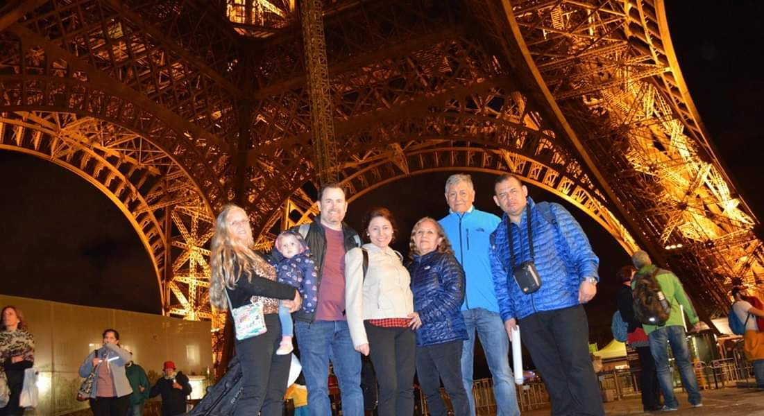 Brown family standing under the Eiffel Tower in Paris Brown family standing under the Eiffel Tower in Paris